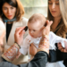 A touching moment during a baby's baptism, showcasing family and religious traditions.